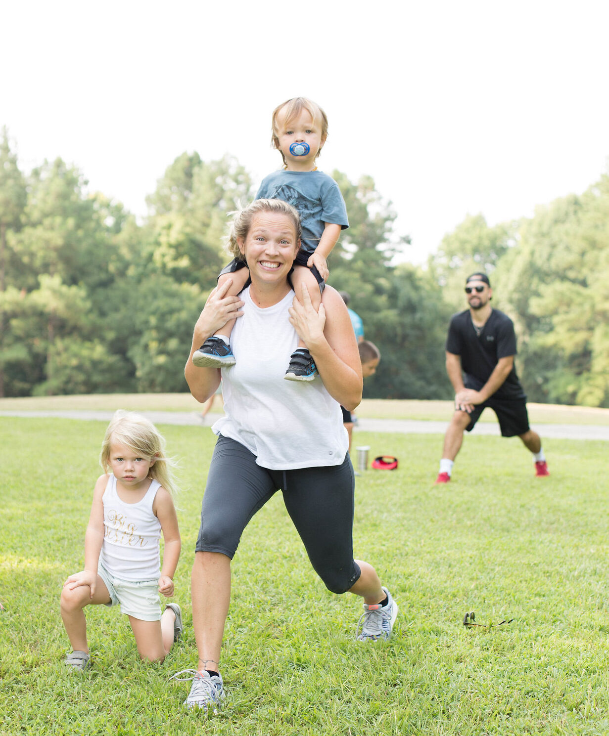 mom working out with two young kids.