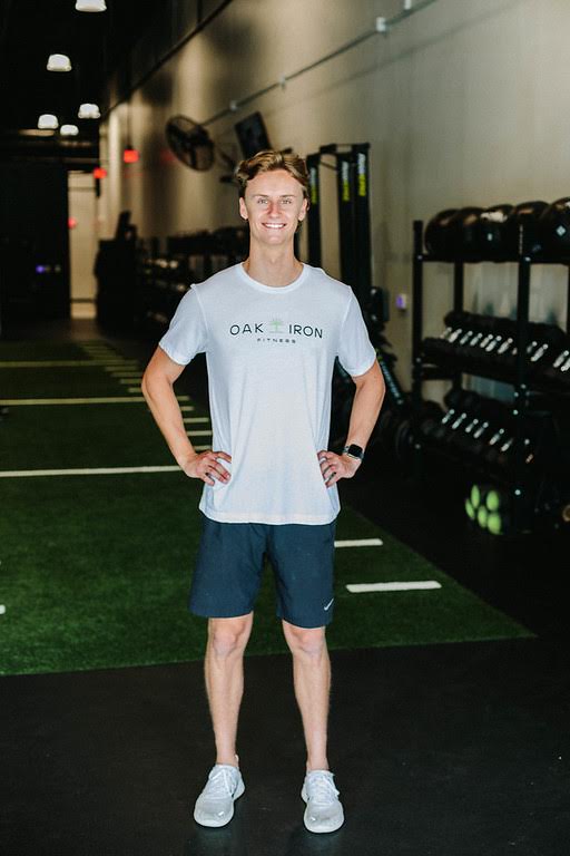 Full body photo of Trainer, Liam Raaen in the gym