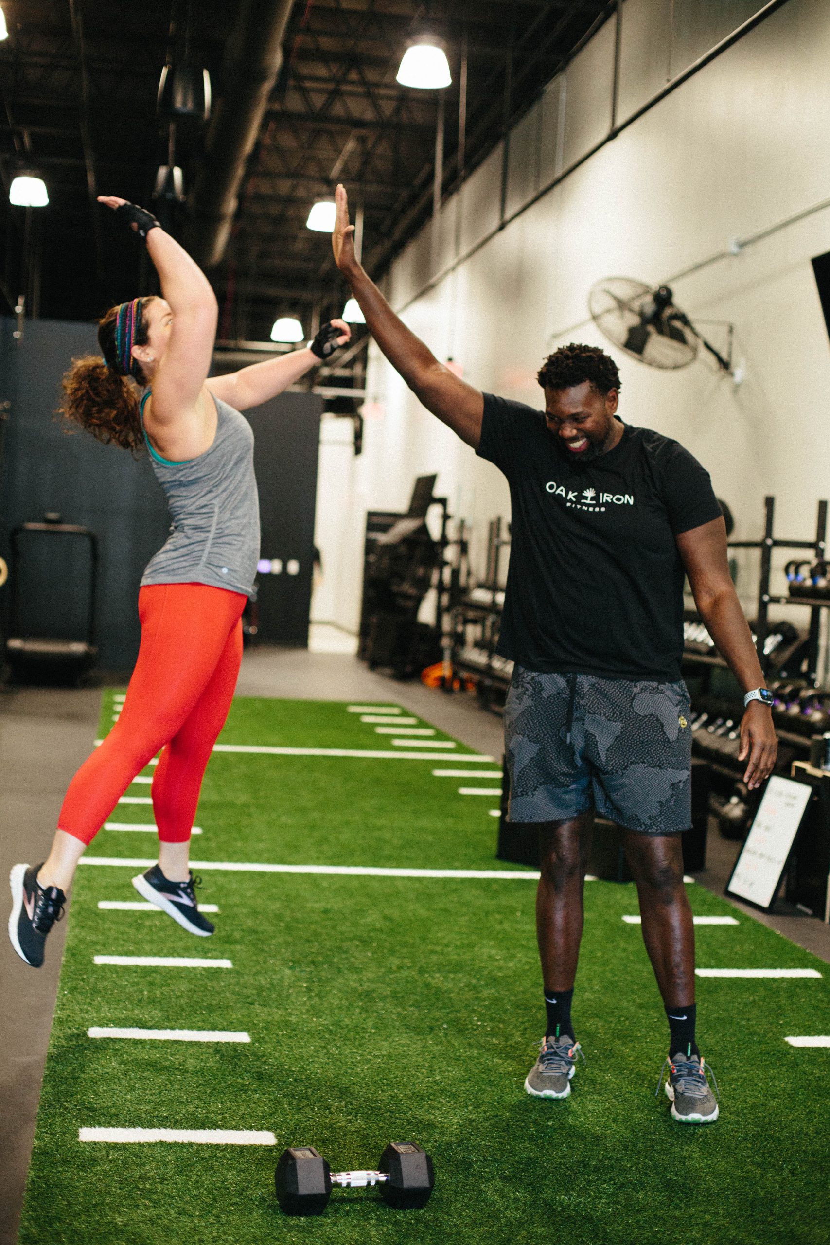 Two people high fiving.