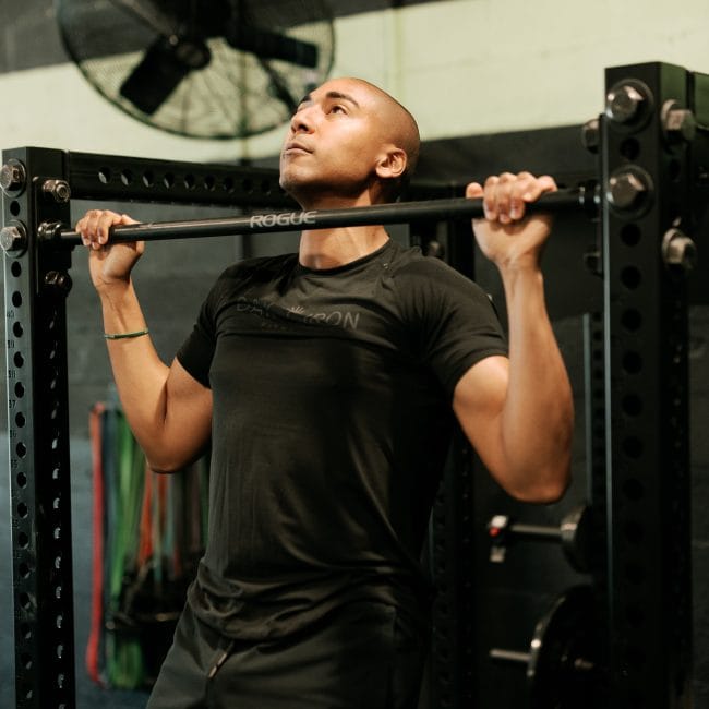 Jamie King - February/March 2025 Member of the Month doing a pull-up